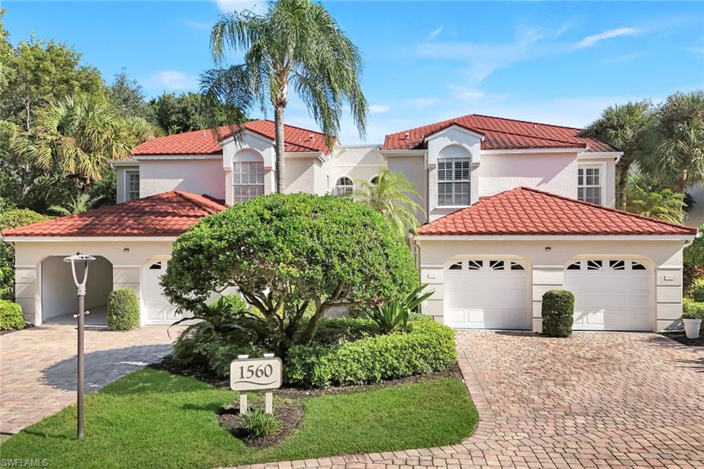 Mediterranean / spanish home with stucco siding, decorative driveway, and a tile roof