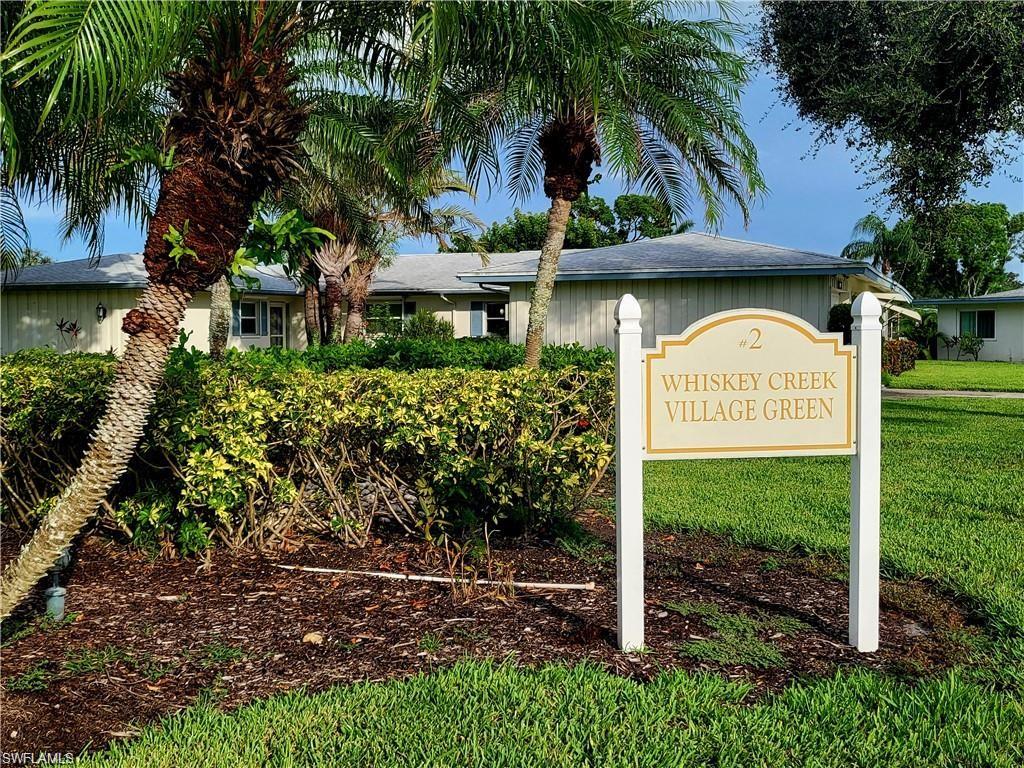 Community / neighborhood sign featuring a lawn