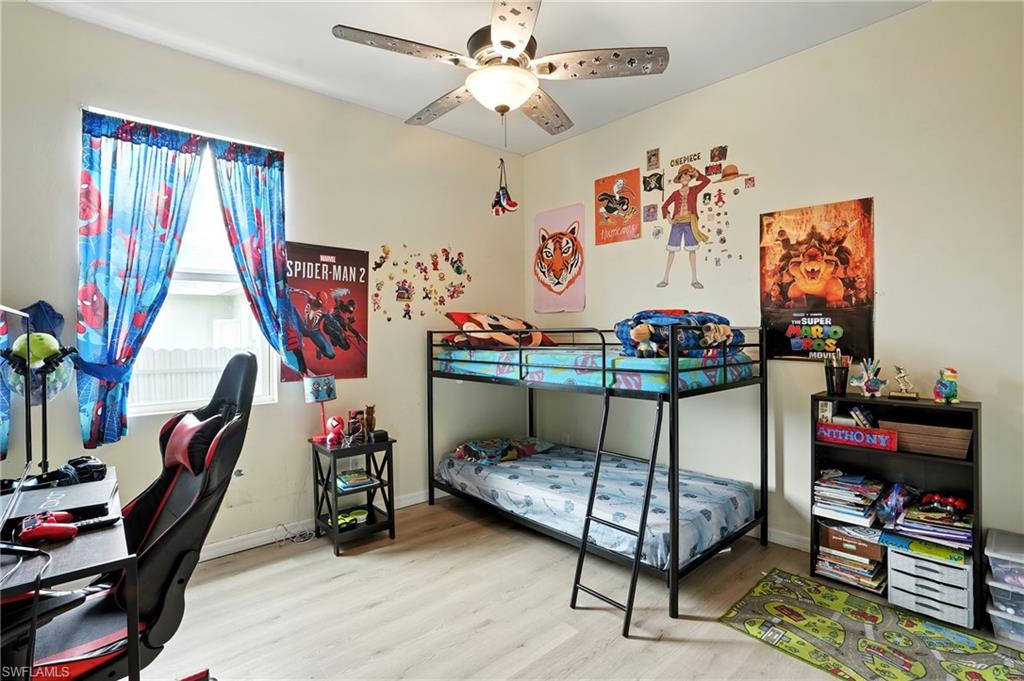 Office space with light wood finished floors and ceiling fan