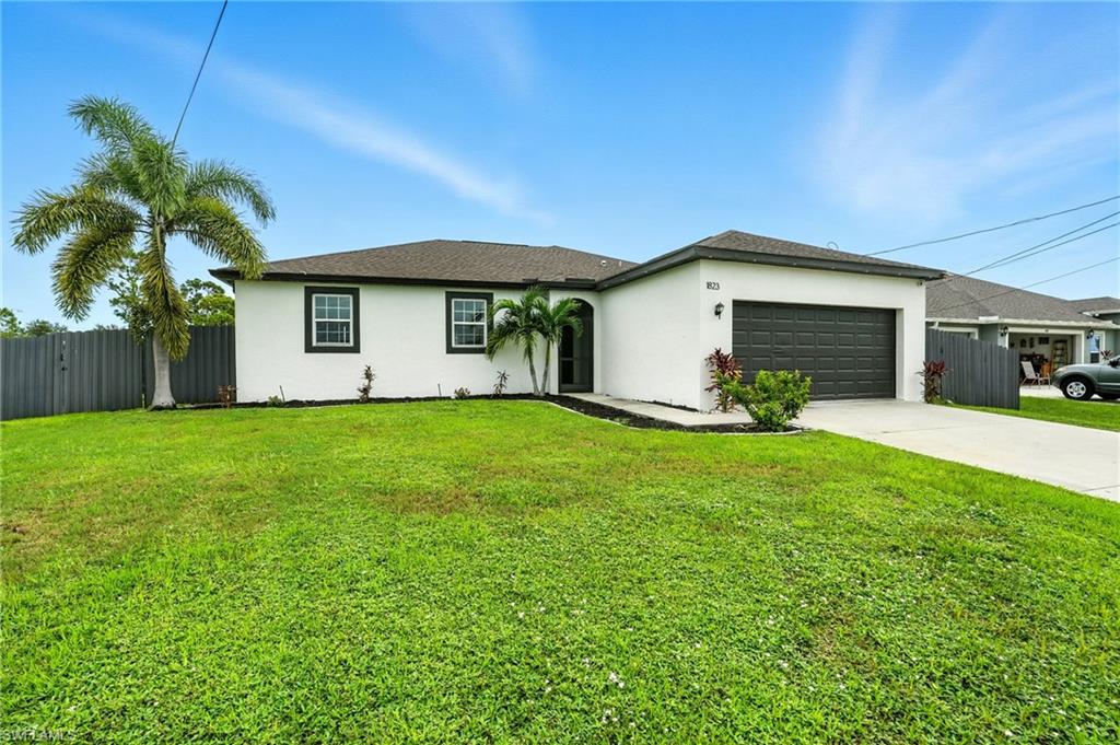 Single story home featuring stucco siding, an attached garage, driveway, and roof with shingles
