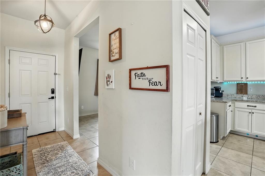 Hall with light tile patterned flooring