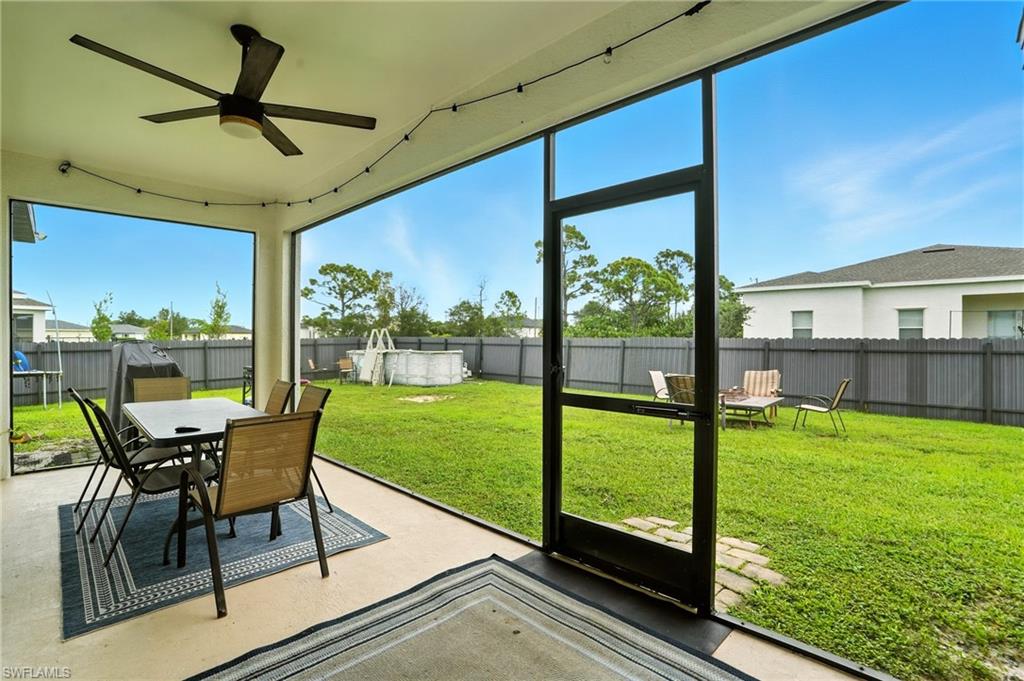 Fenced backyard with outdoor dining space