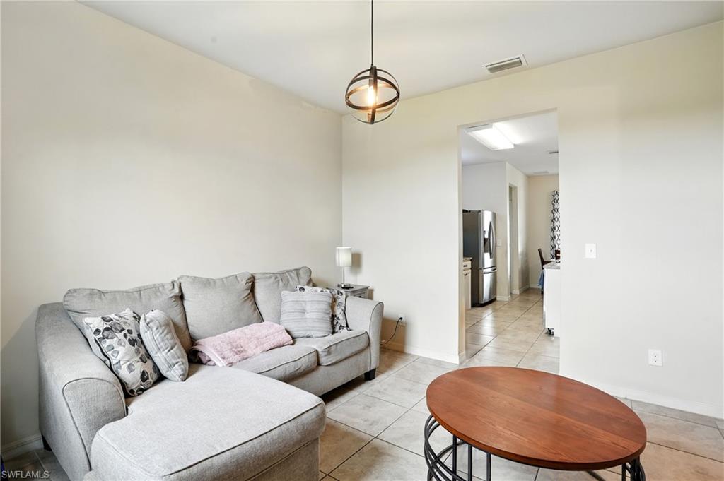 Corridor with light tile patterned floors and baseboards