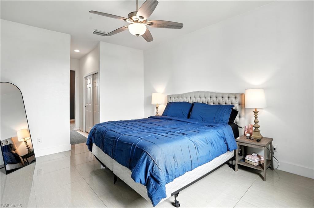 Bedroom featuring a ceiling fan and baseboards