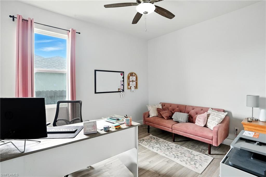 Tiled living room featuring baseboards