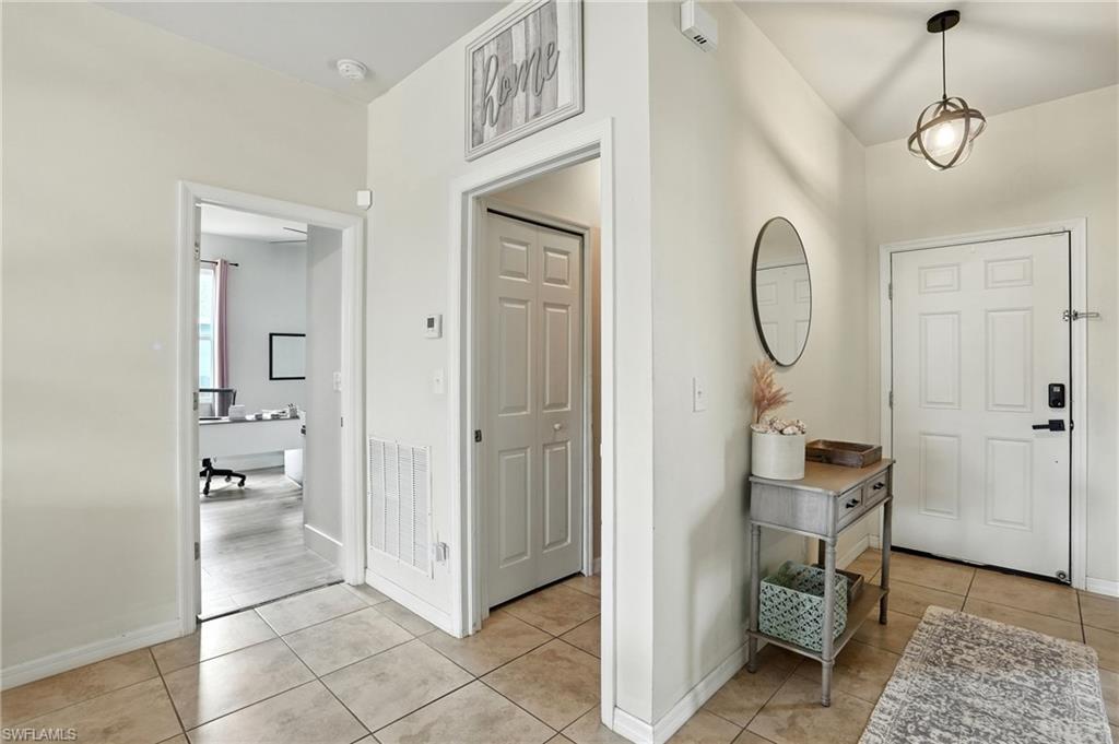 Entryway with light tile patterned floors