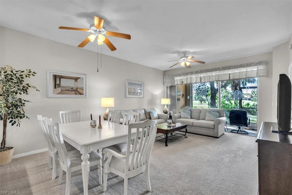 Dining room with light colored carpet and ceiling fan