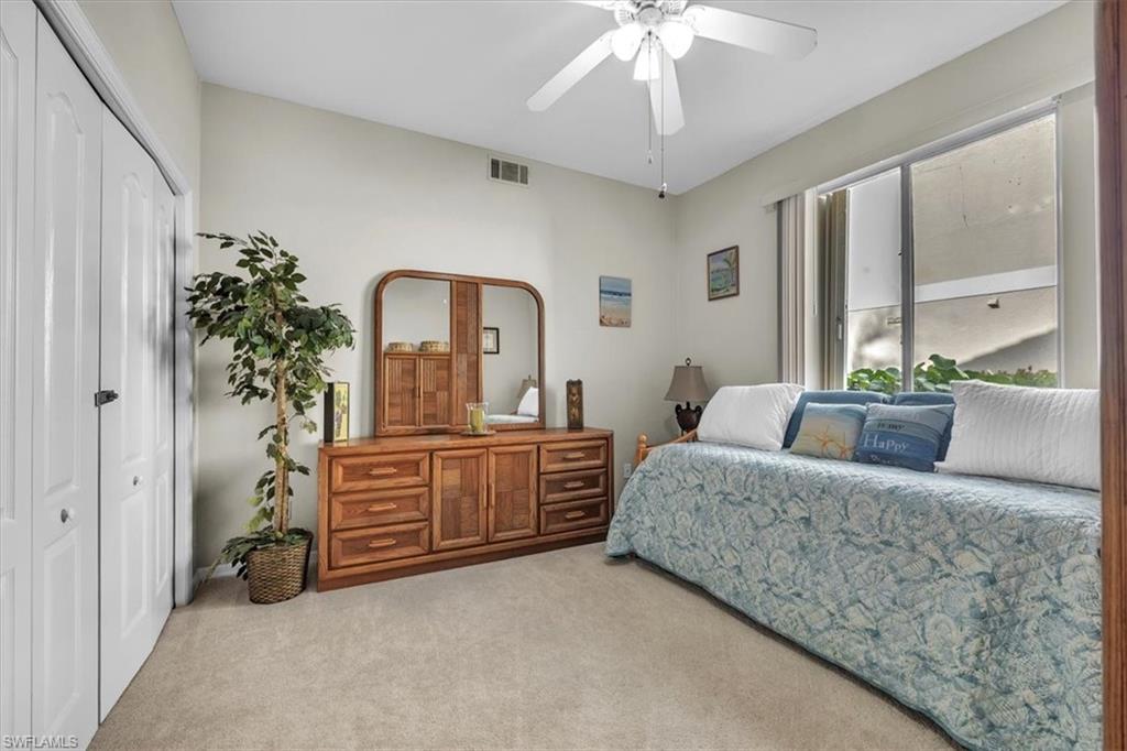 Bedroom with carpet flooring, a closet, and a ceiling fan