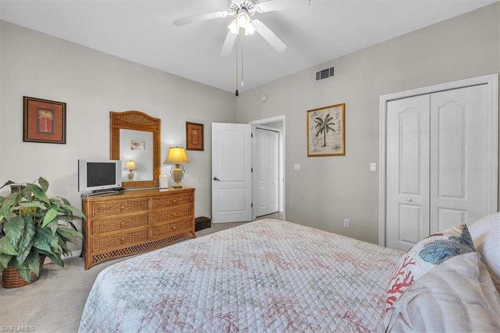 Carpeted bedroom featuring a closet and a ceiling fan