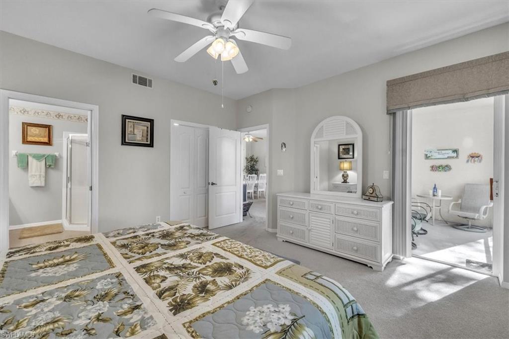 Bedroom featuring light colored carpet, a ceiling fan, and a closet