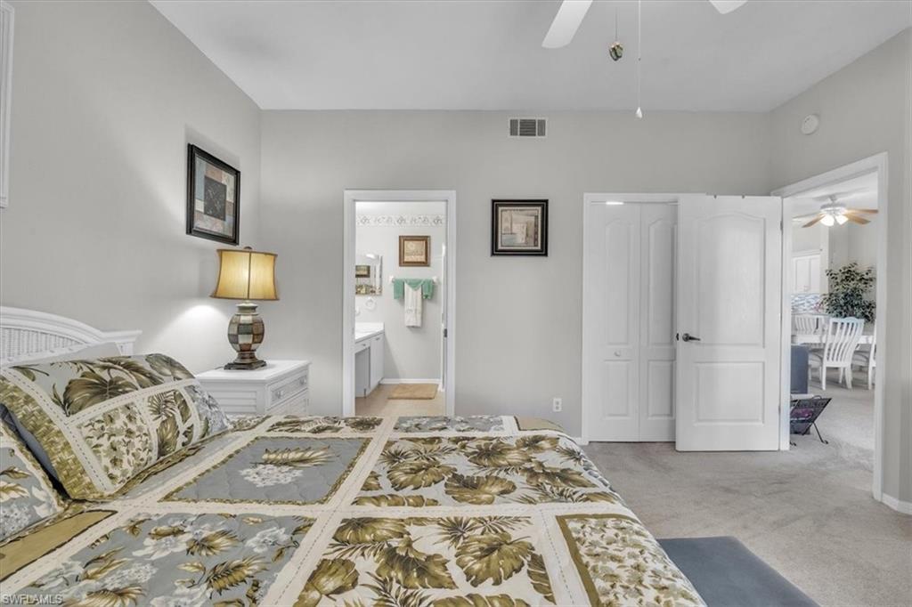 Bedroom featuring a closet, light carpet, and a ceiling fan