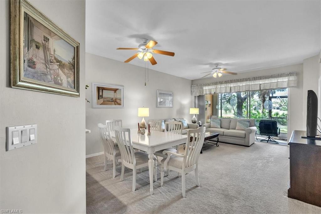 Dining area featuring a ceiling fan and carpet floors