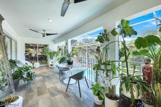 Sunroom / solarium featuring ceiling fan