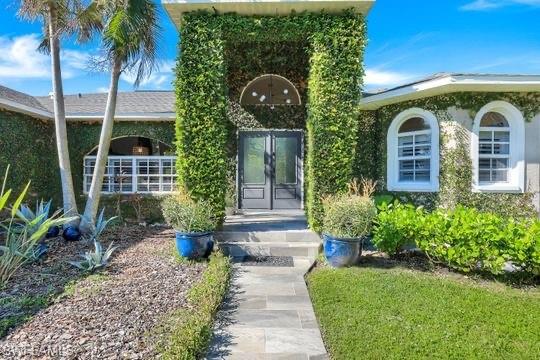 Property entrance featuring french doors