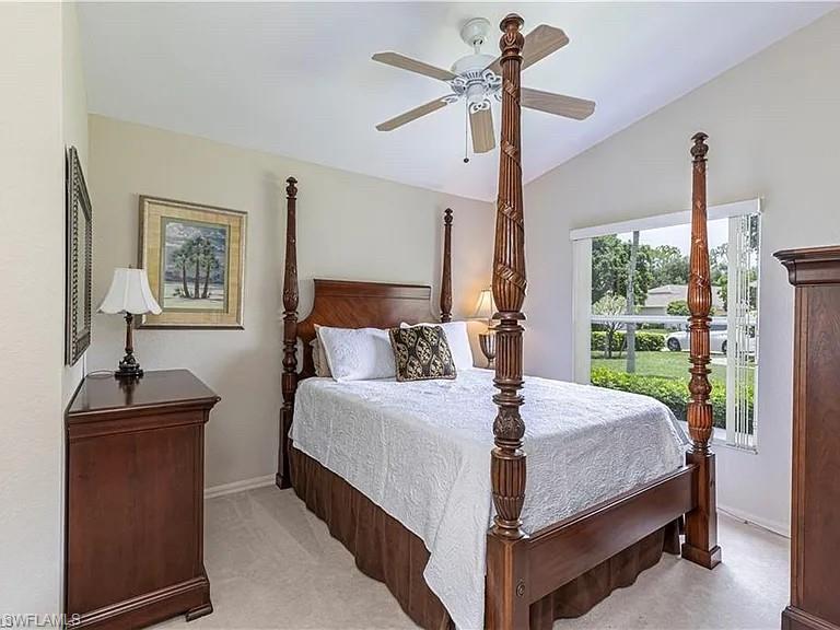 Bedroom featuring vaulted ceiling, a ceiling fan, and light colored carpet