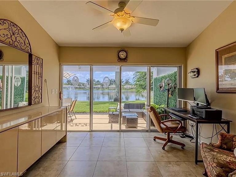 Office with a ceiling fan and light tile patterned floors