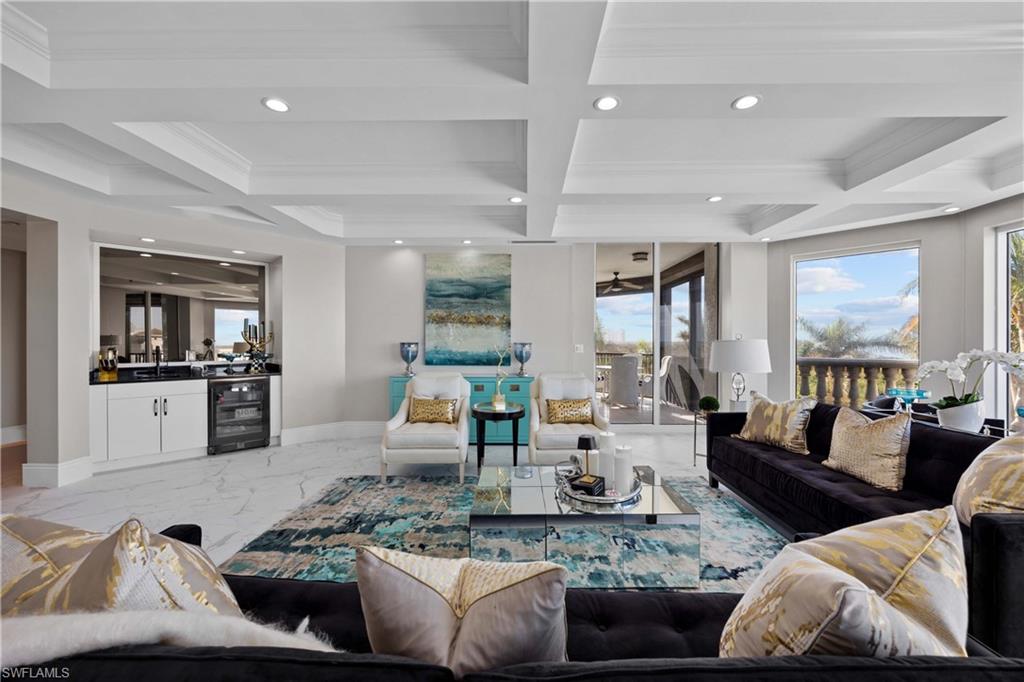 Living room featuring beam ceiling, crown molding, beverage cooler, and coffered ceiling