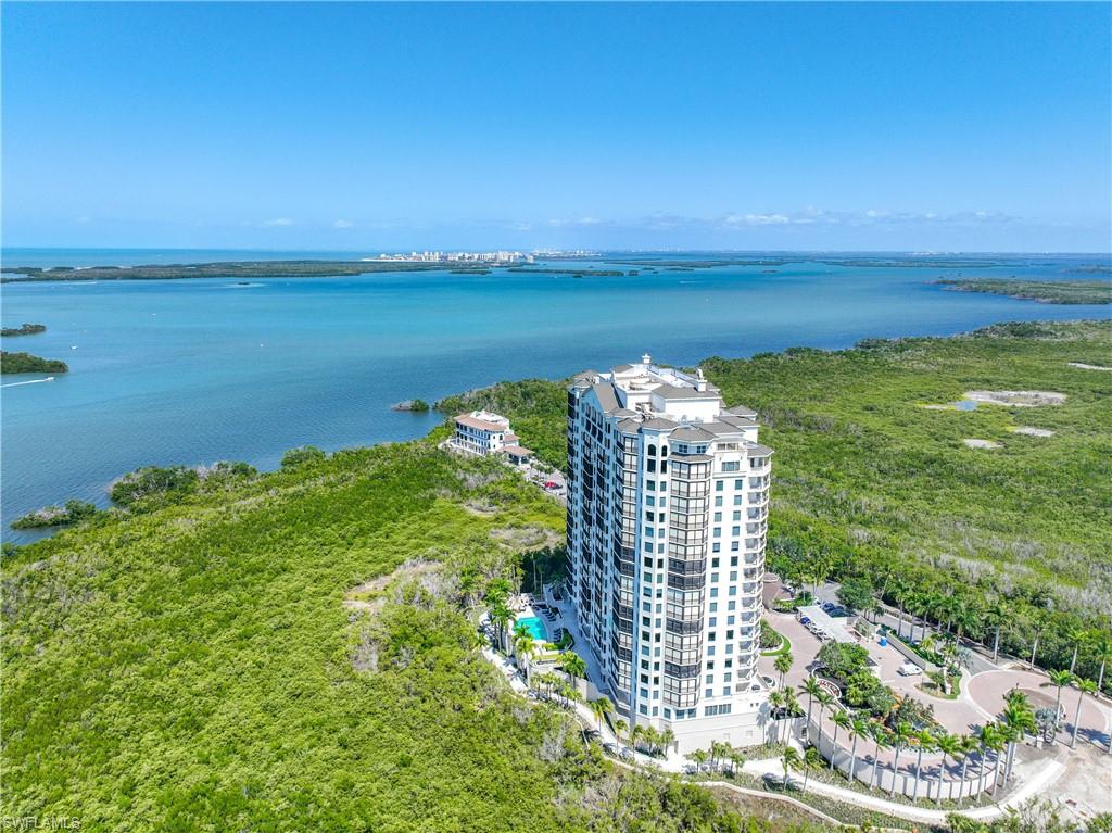 Birds eye view of property with a water view