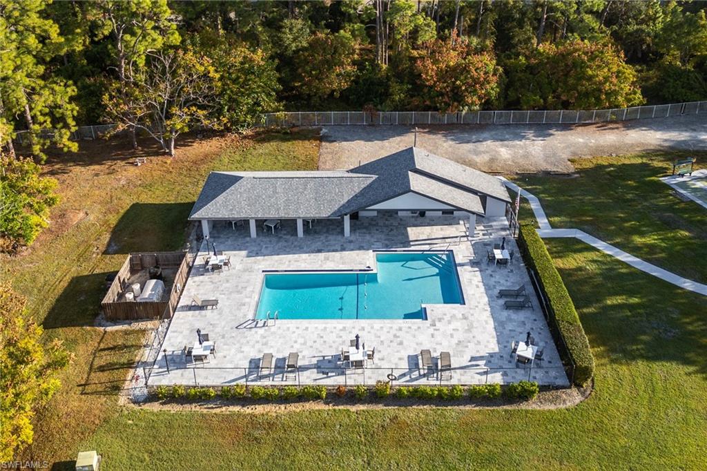 Aerial view of property and surrounding area featuring a pool