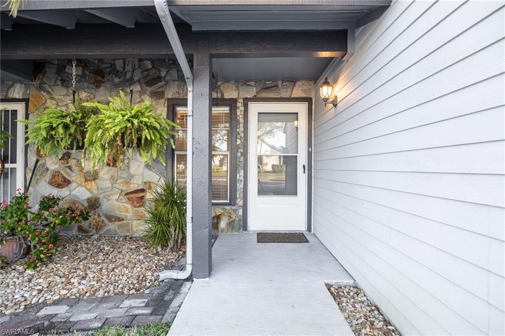 Property entrance featuring stone siding