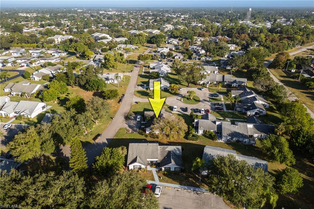 Aerial view of property and surrounding area featuring nearby suburban area
