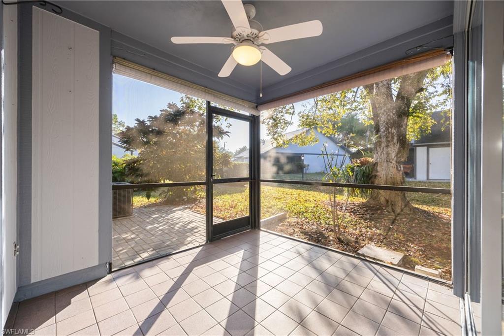 Unfurnished sunroom featuring a ceiling fan and plenty of natural light