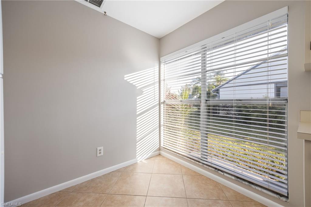 Unfurnished room featuring light tile patterned floors and baseboards