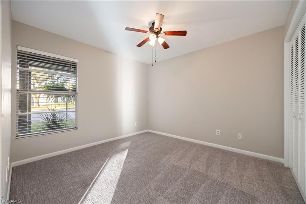 Unfurnished bedroom featuring carpet flooring, a ceiling fan, and a closet