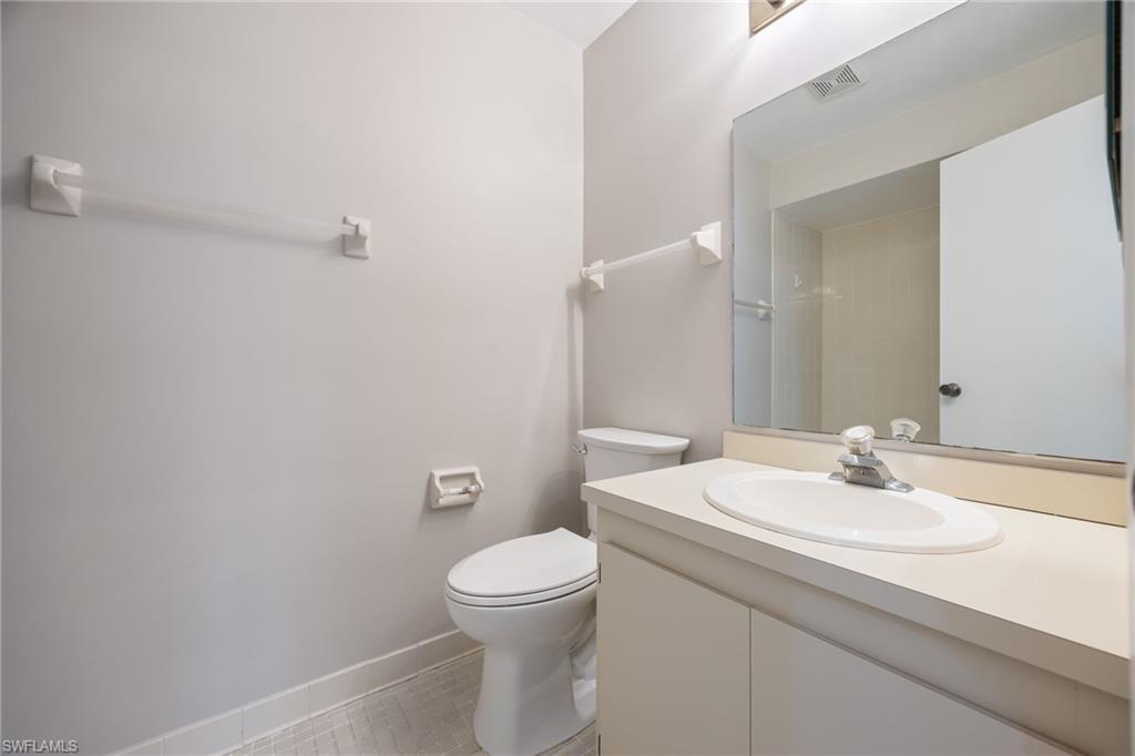 Full bathroom featuring vanity, light tile patterned floors, and a shower