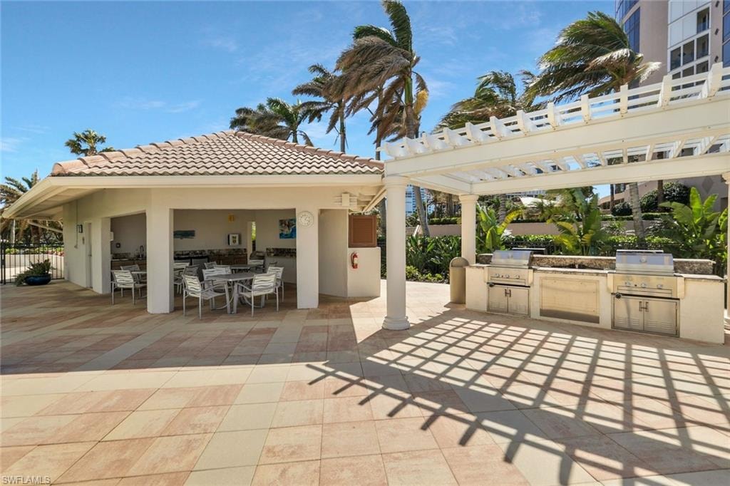 Outdoor grilling area and patio next to pool.