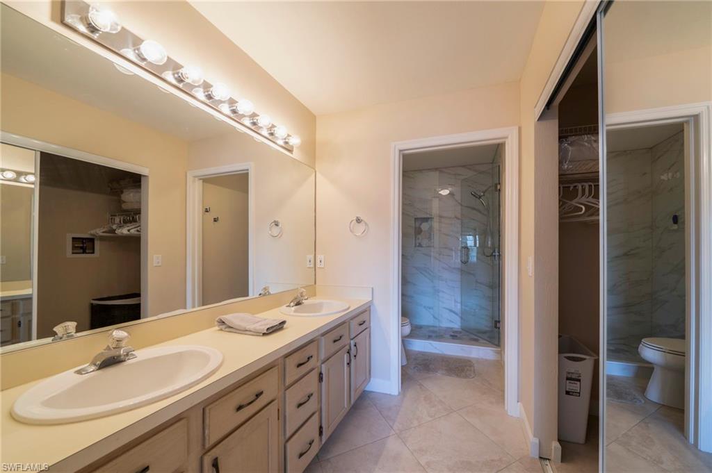 Primary offers dual sinks with a updated shower (2025') and walk-in closet