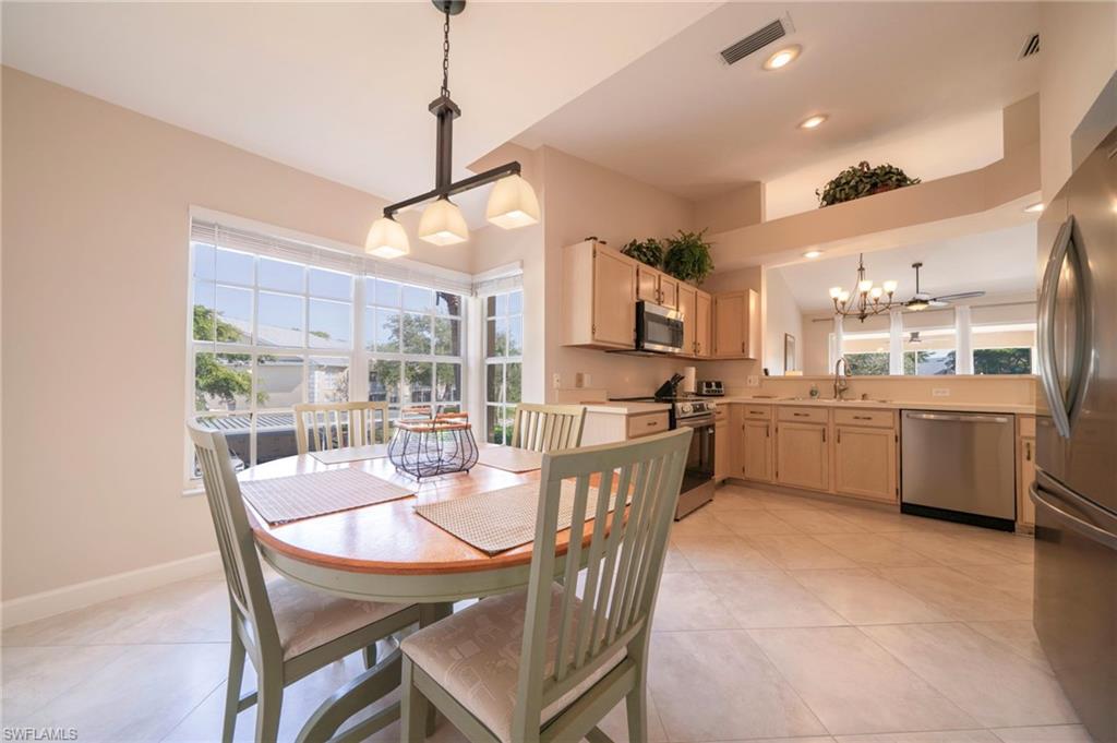 Kitchen Dining with large windows allowing for plenty of natural light overlooking the kitchen with all new stainless appliances (12/25)