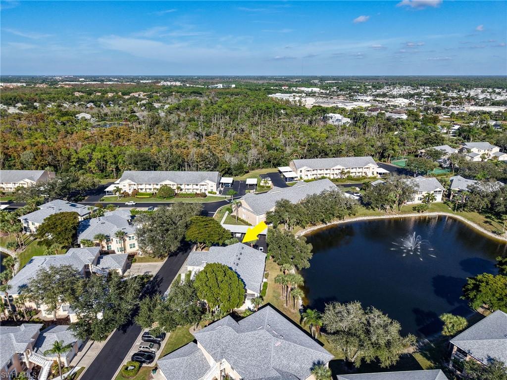 Aerial view of property showing view of lake and water feature.