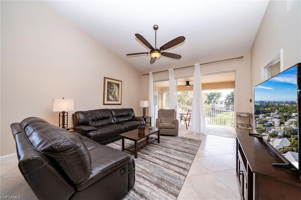 Living area with vaulted ceiling leading out to your lake view and screened lanai