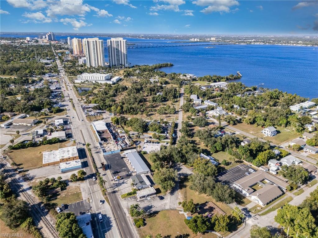 Aerial view of property's location with a large body of water
