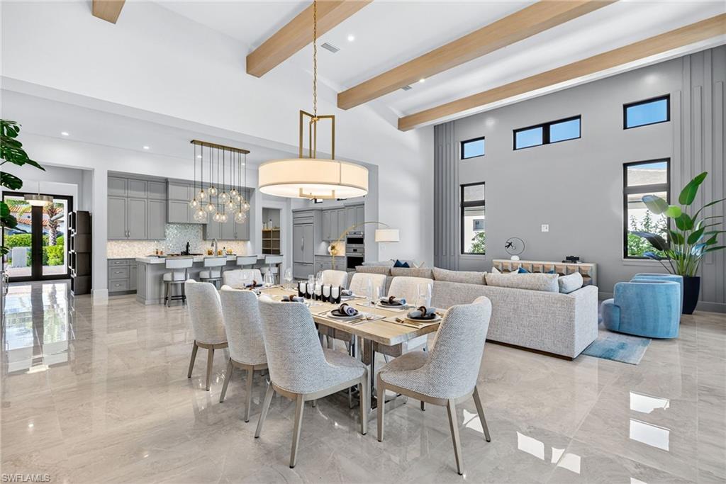 Seamlessly connected to the living space, the spacious dining area comfortably accommodates large gatherings and is anchored by a contemporary chandelier