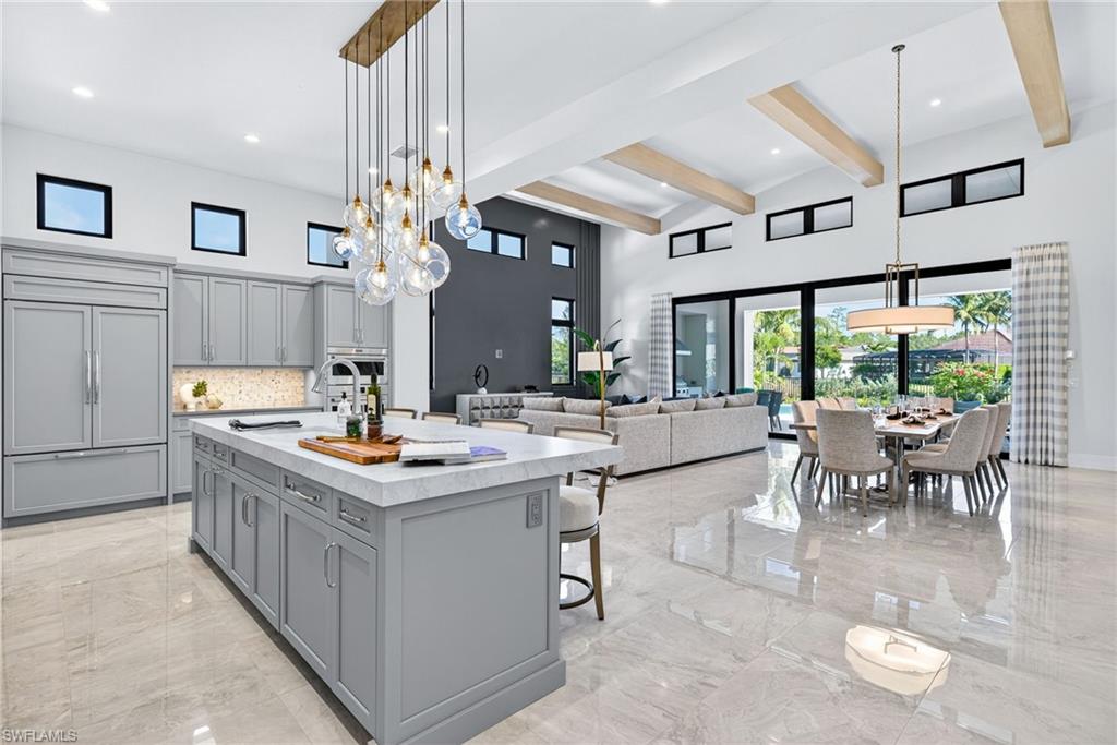 Expansive great room seamlessly integrates the gourmet kitchen, living, and dining areas, creating an ideal environment for both intimate gatherings and grand-scale entertaining.