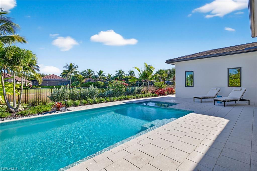 Custom pool surrounded by tropical flowers and trees
