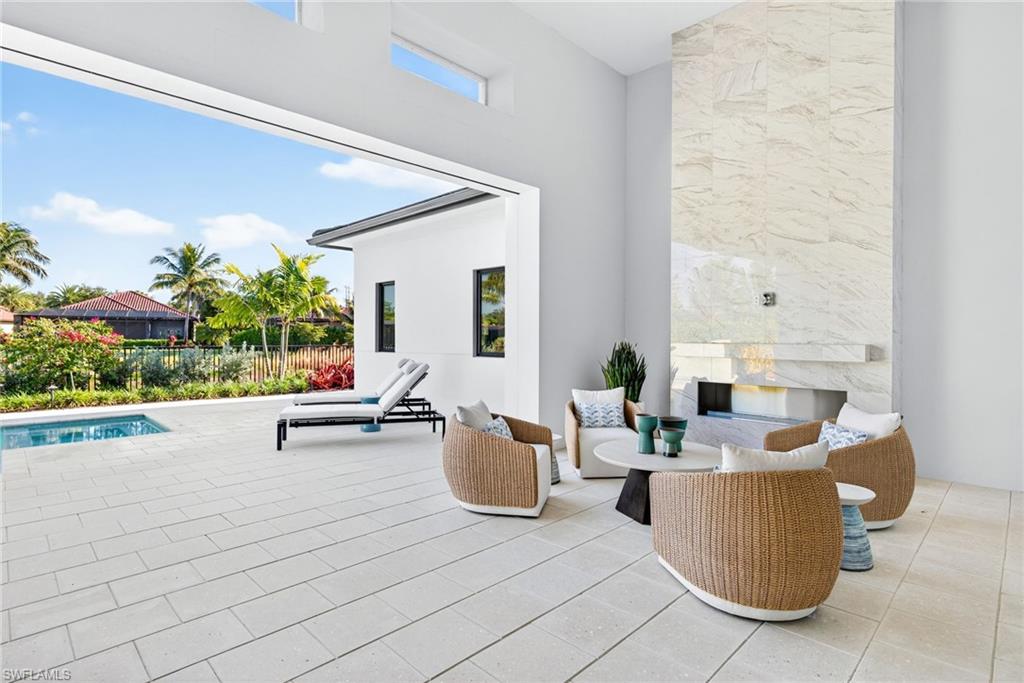 Patio seating area with gorgeous marble mantel and gas fireplace