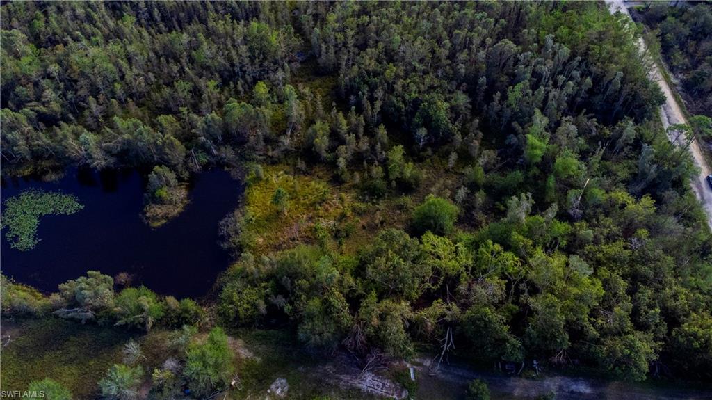 Aerial view of property's location with a large body of water