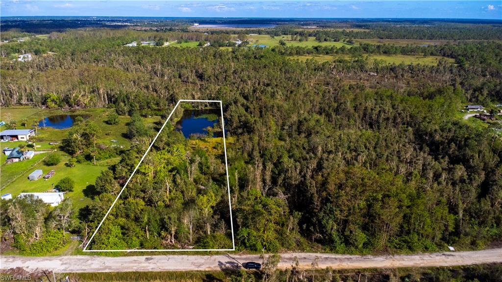 Aerial overview of property's location featuring property parcel outlined and a large body of water