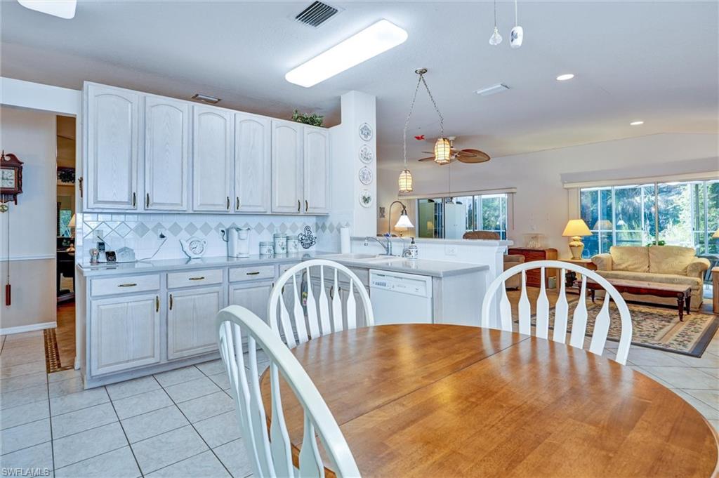 Kitchen featuring white cabinetry, tile backsplash, and a white countertop