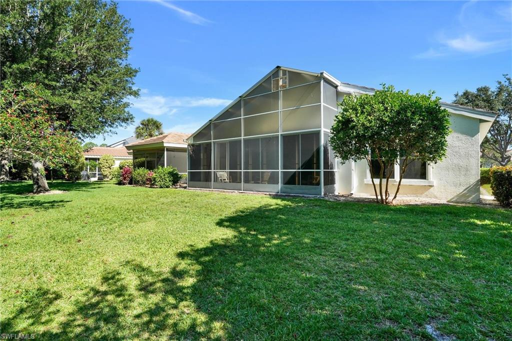 Expansive green lawn with mature trees and perimeter landscaping