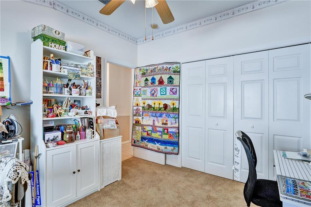 Room featuring carpet flooring and a ceiling fan