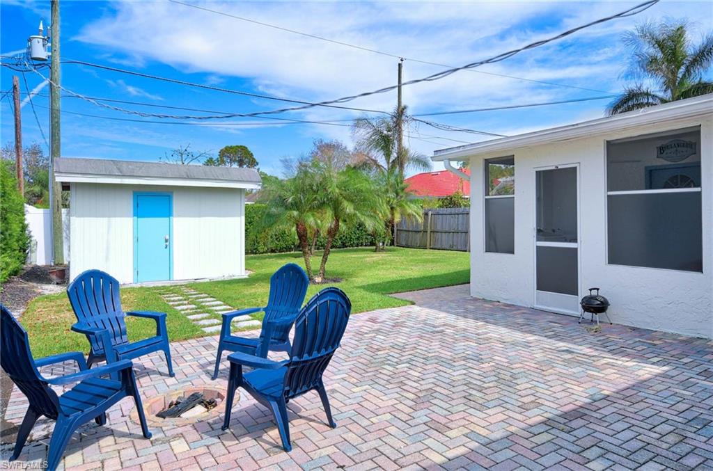 Fenced backyard with a patio area and a storage unit