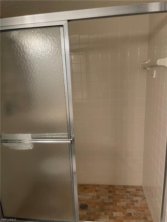 Full bathroom featuring a stall shower