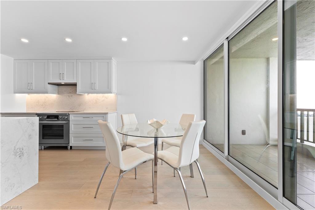 Dining area with recessed lighting, light wood finished floors, and floor to ceiling windows