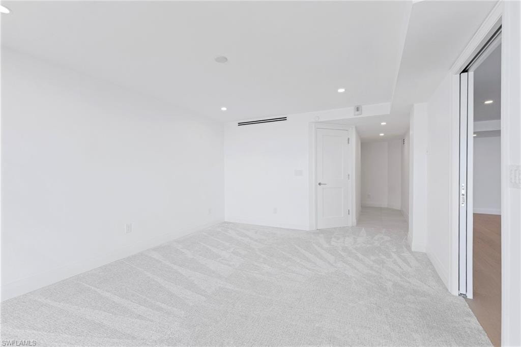 Unfurnished bedroom featuring recessed lighting and light carpet