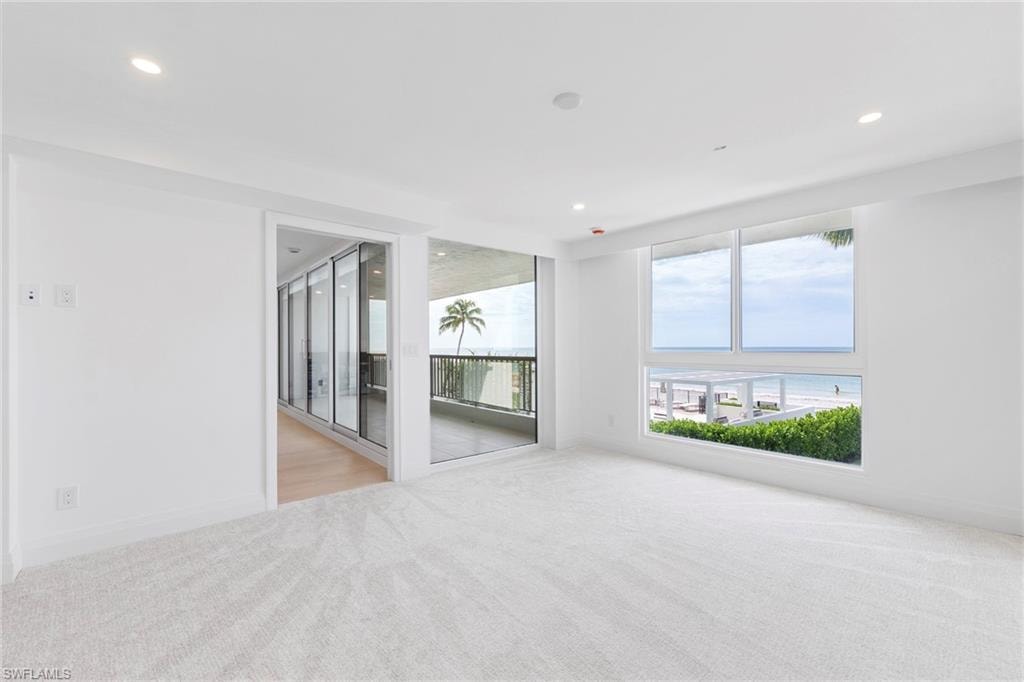 Spare room with a water view, recessed lighting, and light colored carpet