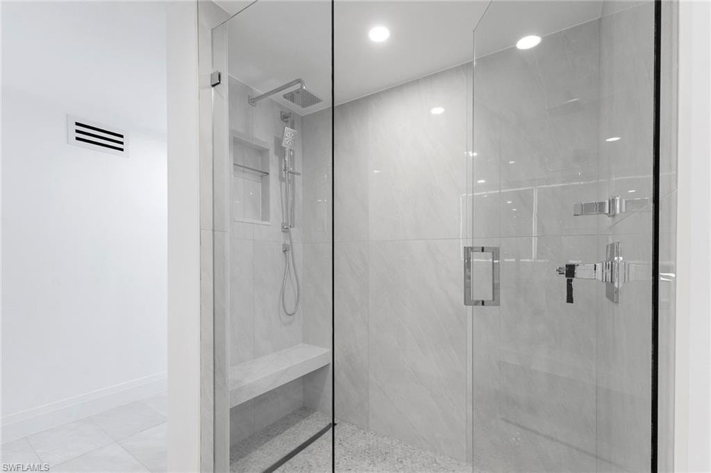 Bathroom featuring a marble finish shower